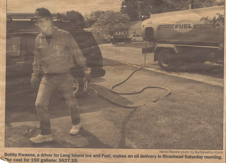 an old newspaper cutout of a man infront of a fuel truck