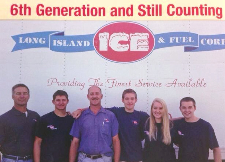 a group of 6 people infront of the long island ice and fuel truck