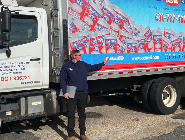 a man standing next to a fuel truck