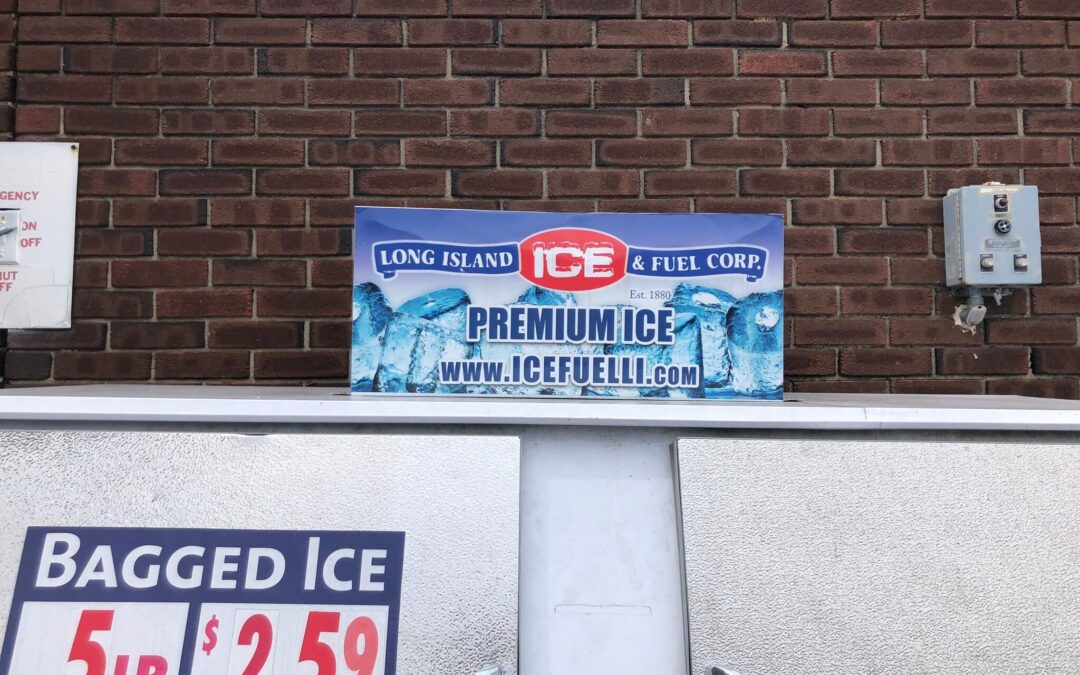 A photo of a bagged ice freezer against a brick wall