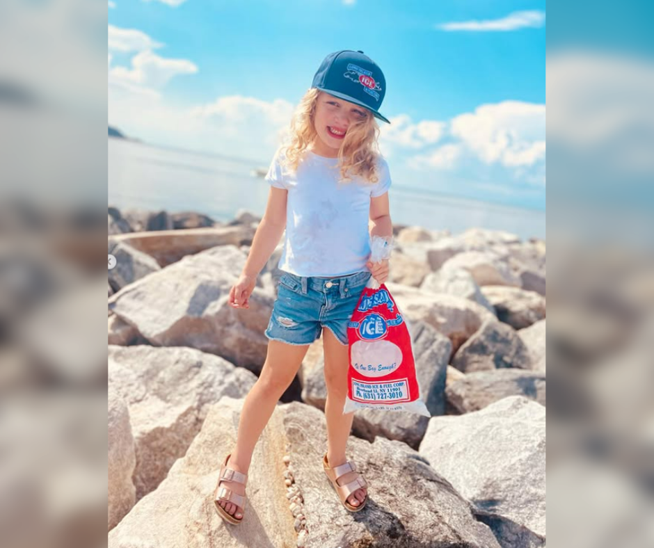 Girl holding bag of packaged ice from Long Island Ice and Fuel of Suffolk County, NY
