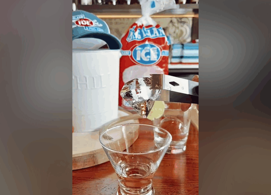 A photo of custom diamond-shaped gourmet ice in a beautiful glass on a counter